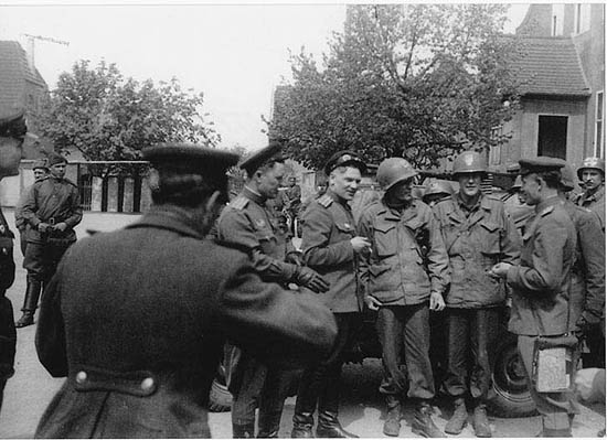 A photo of the same scene, taken by American Private Igor Belousovitch who was in Major Craig’s patrol (Craig is the leftmost American – they all put helmets on), shows most probably Ustinov working. Source: The Moscow Times
