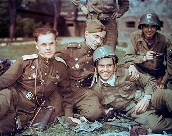 American Lieutenant Dwight Brooks (center, in helmet) smiles as he and other members of the 69th Infantry Division pose with Soviet officers from the 58th Guards Division in the German town of Torgau, Germany, late April, 1945. Photo by PhotoQuest/Getty Images. Source: waralbum.ru